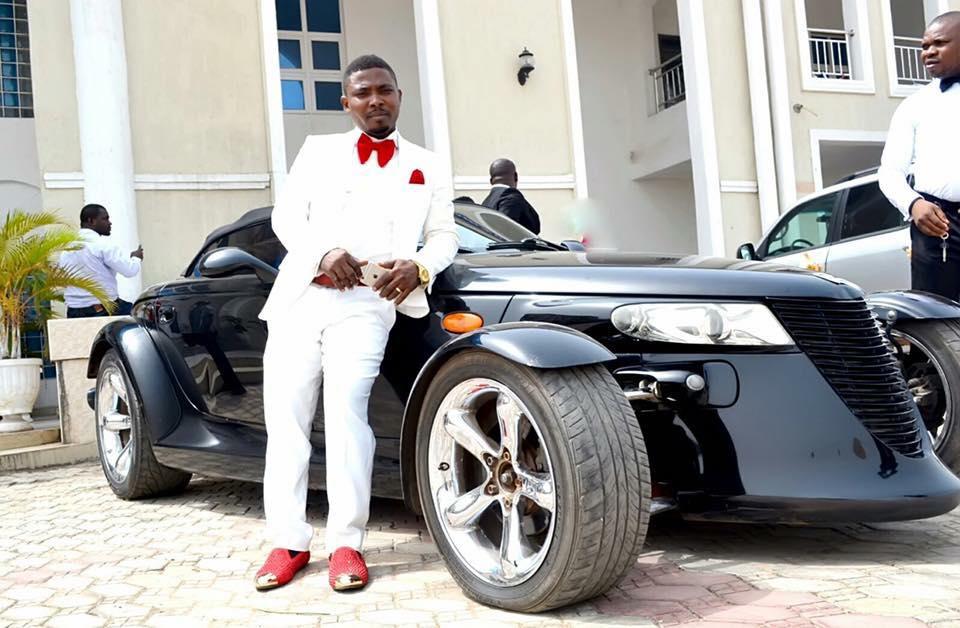 Onuegwu Ifeanyi, also known as "SSG Toolz," poses next to a Plymouth Prowler. 