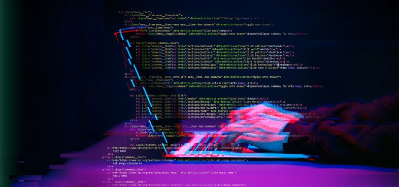 A dynamic visual of computer code projected over a blurred keyboard, emphasizing vibrant pink and blue digital effects. The code includes various elements like 'class', 'id', 'div', and HTML tags, reflecting a programming environment.