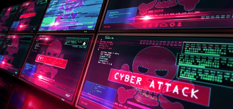 Multiple computer screens displaying various graphics and text related to a cyber attack, including a prominent skull symbol and warnings in red. Text on one screen reads "Cyber Attack" in large, bold letters.