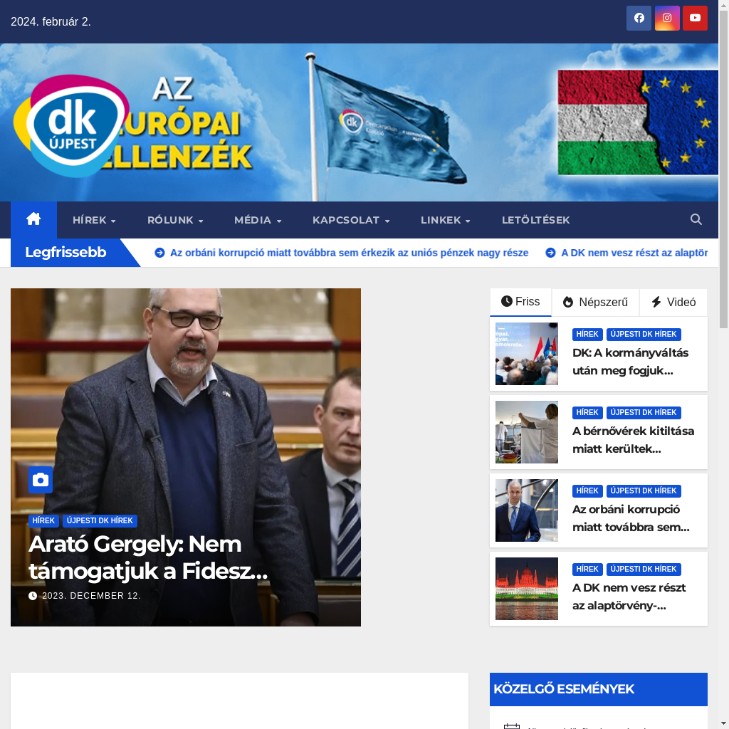 News website homepage featuring various articles, logos and an image of a person speaking at a podium with another individual in the background, under the headline about an ongoing conference.