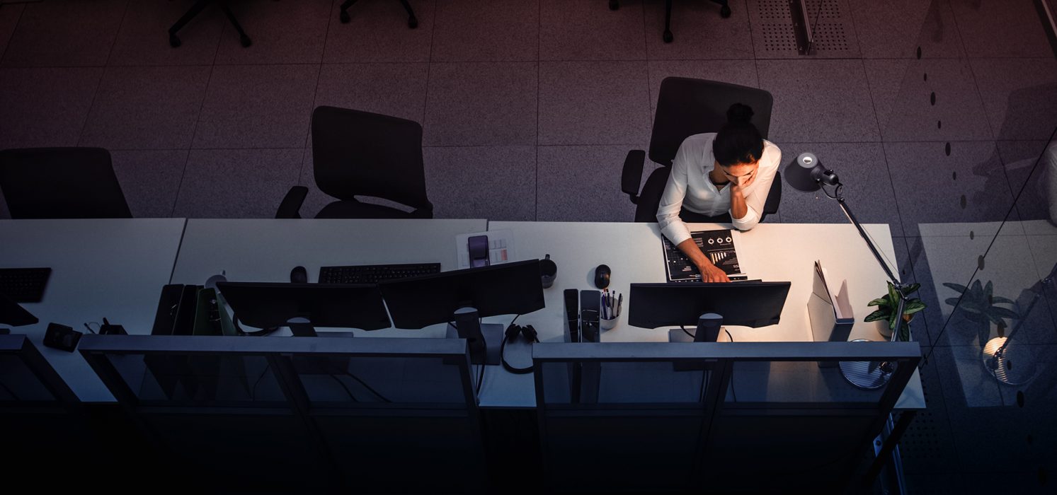 Pictorial representation of an aerial view of an individual working on a cumputer in an office setting.